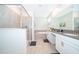 Modern primary bathroom featuring dual vanities, soaking tub, and glass-enclosed shower at 830 Sticks, Davenport, FL 33896