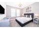 Chic primary bedroom with dark gray walls, soft textiles, and elegant chandelier at 830 Sticks, Davenport, FL 33896