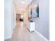 Bright hallway with neutral tile, modern art, and an open view into the living space at 830 Sticks, Davenport, FL 33896