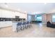 Spacious kitchen with white cabinetry, stainless steel appliances, a breakfast bar, and tiled floors at 830 Sticks, Davenport, FL 33896