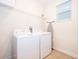 Functional laundry room with washer, dryer, shelving, and natural light from a window at 830 Sticks, Davenport, FL 33896