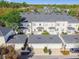 Aerial view of townhomes with garages, patios, and well-maintained landscaping at 906 Blue Sage St, Kissimmee, FL 34747