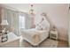 Elegant bedroom with soft pink accents, stylish lighting, and a luxurious bed at 906 Blue Sage St, Kissimmee, FL 34747