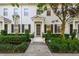 Inviting townhome entrance with a well-kept lawn, classic black shutters, and a welcoming front door at 906 Blue Sage St, Kissimmee, FL 34747