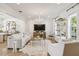 Bright living area with a chandelier, plush seating, and an open concept layout leading to the kitchen at 906 Blue Sage St, Kissimmee, FL 34747