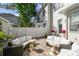 Outdoor patio area with ample seating, brick pavers, and lush landscaping creating a private retreat at 906 Blue Sage St, Kissimmee, FL 34747