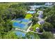 Aerial view of well-maintained tennis courts with lush landscaping and community amenities at 906 Blue Sage St, Kissimmee, FL 34747