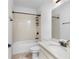 Well-lit bathroom featuring tile flooring, a bathtub and shower combination, and a vanity with countertop at 9149 Grand Island Way, Winter Garden, FL 34787