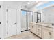 Bright bathroom features a dual sink vanity and a glass-enclosed shower at 9149 Grand Island Way, Winter Garden, FL 34787