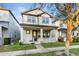 Inviting two-story home featuring a covered front porch, complemented by neat landscaping and sidewalk at 9149 Grand Island Way, Winter Garden, FL 34787