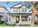 Charming two-story home with a welcoming front porch and manicured lawn in a modern neighborhood at 9149 Grand Island Way, Winter Garden, FL 34787