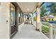 Inviting front porch with support columns, a concrete floor, and neighborhood views at 9149 Grand Island Way, Winter Garden, FL 34787