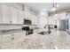 Island kitchen boasts stainless steel appliances, granite counters and custom cabinets at 9149 Grand Island Way, Winter Garden, FL 34787