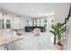 Open living room featuring marble floors, modern decor, large windows, and a stairwell at 9149 Grand Island Way, Winter Garden, FL 34787