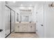 Main bathroom with dual sinks, enclosed glass shower, and bright natural light at 9149 Grand Island Way, Winter Garden, FL 34787