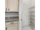 Pantry featuring granite counters, white cabinets and convenient metal shelving at 9149 Grand Island Way, Winter Garden, FL 34787