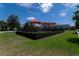 Community playground with shade canopies, surrounded by a well-maintained lawn and hedges at 9149 Grand Island Way, Winter Garden, FL 34787