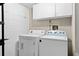 Laundry area with white washer and dryer, and storage cabinets at 936 Summer Lakes Dr, Orlando, FL 32835