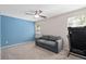 Cozy room with blue accent wall and small gray sofa at 936 Summer Lakes Dr, Orlando, FL 32835