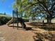 A fun playground area for children with slides and swings, set against the backdrop of the lake at 936 Summer Lakes Dr, Orlando, FL 32835