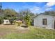 View of the expansive backyard with lush green grass and mature trees in a partially fenced yard at 1022 Glenharbor Cir, Winter Garden, FL 34787