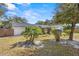 Well manicured backyard with several landscaped plantings and partial view of the home at 1022 Glenharbor Cir, Winter Garden, FL 34787