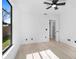 Bedroom featuring light wood floors, a window, and a door to the bathroom at 1022 Glenharbor Cir, Winter Garden, FL 34787