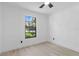 A bright bedroom featuring light wood floors and a window at 1022 Glenharbor Cir, Winter Garden, FL 34787