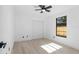 Bedroom featuring a closet, light wood floors, and a window at 1022 Glenharbor Cir, Winter Garden, FL 34787