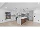 Bright kitchen with a center island, stainless steel appliances, white cabinetry, and sleek finishes, flowing into living space at 1022 Glenharbor Cir, Winter Garden, FL 34787