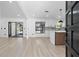 Bright and airy living room and kitchen featuring modern flooring, white walls, and stylish black-trimmed windows at 1022 Glenharbor Cir, Winter Garden, FL 34787