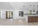 Open-concept living room and kitchen area, showcasing sleek flooring and contemporary finishes and modern fixtures at 1022 Glenharbor Cir, Winter Garden, FL 34787