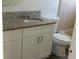 Clean bathroom with granite countertops, modern cabinets, and a toilet next to tub at 1059 Manigan Ave, Oviedo, FL 32765