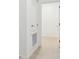 Bright hallway featuring neutral tile flooring and a doorway leading to another room at 1210 Normandy Dr, Haines City, FL 33844