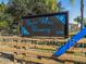 Charming True Blue Winery sign with decorative accents, set against a backdrop of trees and clear blue sky at 1210 Normandy Dr, Haines City, FL 33844