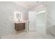 Bright bathroom featuring marble-style tiling, modern vanity, and illuminated mirror at 1215 Crawford Ave, St Cloud, FL 34769