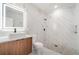 Bathroom featuring marble-style tiling, modern vanity, and pebble tile shower floor at 1215 Crawford Ave, St Cloud, FL 34769