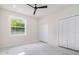 Bright bedroom featuring marble-style flooring, natural light, and closet at 1215 Crawford Ave, St Cloud, FL 34769