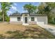 Front exterior of home featuring a modern design with a dark roof at 1215 Crawford Ave, St Cloud, FL 34769