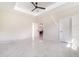 Spacious main bedroom featuring tray ceiling, ceiling fan, and view of the bathroom at 1215 Crawford Ave, St Cloud, FL 34769