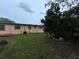 View of backyard featuring green grass and the home's exterior at 1246 Rhodes Ct, Orlando, FL 32808