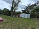 Large backyard featuring a storage shed and shade tree at 1246 Rhodes Ct, Orlando, FL 32808