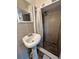 This bathroom features a pedestal sink and a tiled shower with a shower curtain at 1246 Rhodes Ct, Orlando, FL 32808