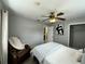 Cozy bedroom featuring a ceiling fan, recliner, and neutral walls at 1246 Rhodes Ct, Orlando, FL 32808