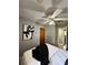 Bedroom with ceiling fan, art deco on the wall, and wood door leading to hallway at 1246 Rhodes Ct, Orlando, FL 32808