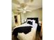 Bedroom with ceiling fan, black headboard, neutral walls and wood-look floors at 1246 Rhodes Ct, Orlando, FL 32808