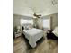 Cozy bedroom featuring wood-look tile flooring, two windows, and a comfortable chair at 1246 Rhodes Ct, Orlando, FL 32808