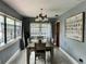 Dining room with wooden table, modern decor, and a view into the kitchen at 1246 Rhodes Ct, Orlando, FL 32808