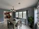 Dining room with a wooden table, wood-look tile flooring, and modern light fixture at 1246 Rhodes Ct, Orlando, FL 32808