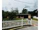 Charming single-story home with a manicured lawn and a classic white picket fence at 1246 Rhodes Ct, Orlando, FL 32808